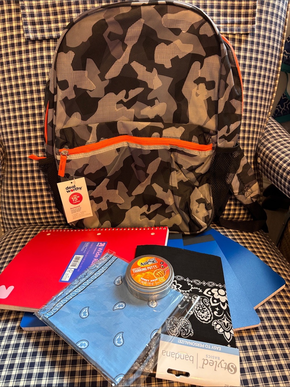 Gray Camo Backpack with Orange Trim loaded with school supplies